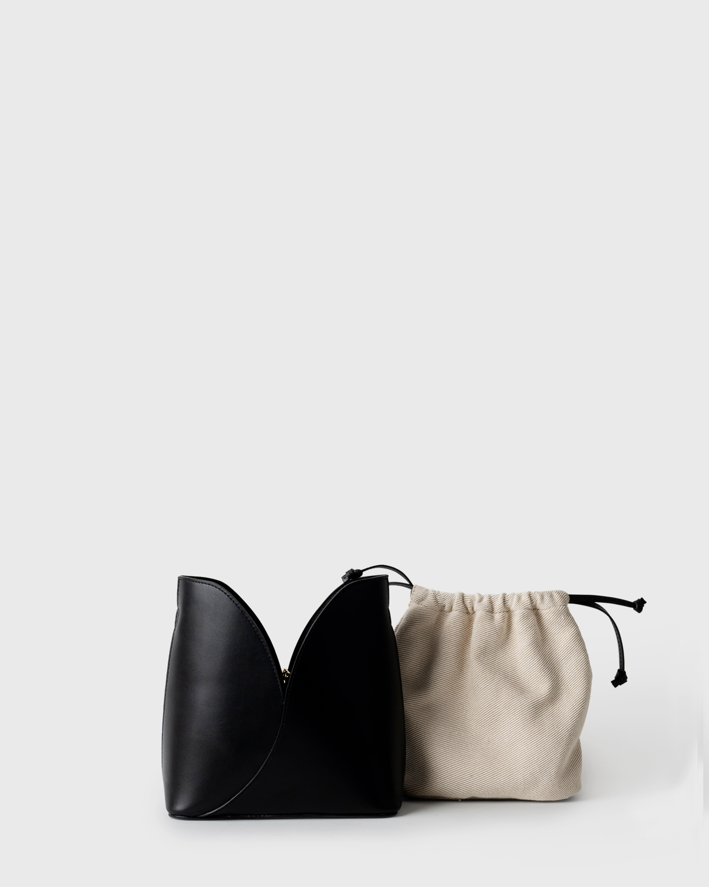 Structured black leather bucket bag with contrast lining and silver hardware