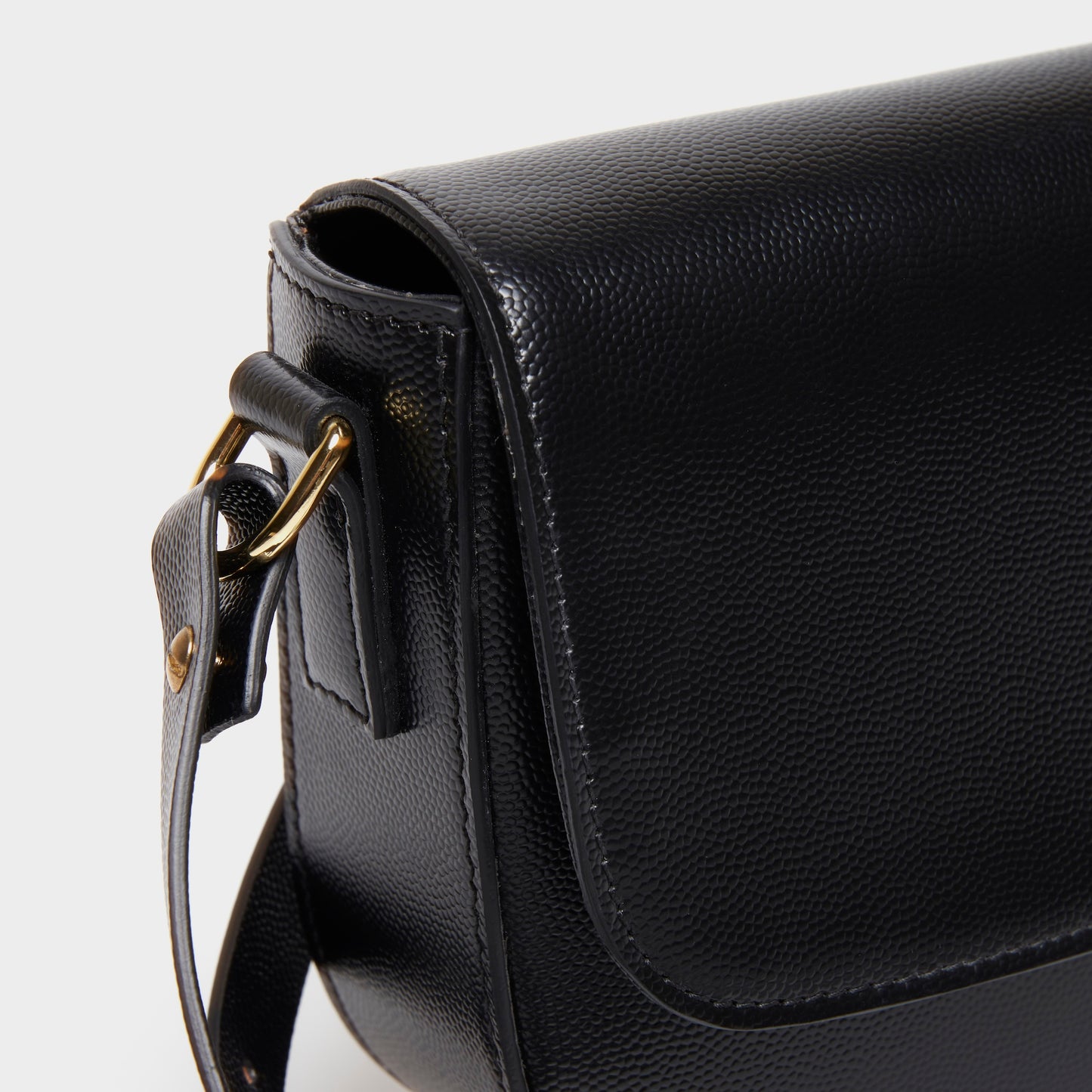 Close-up of curved stitching on BLACK calfskin crossbody bag
