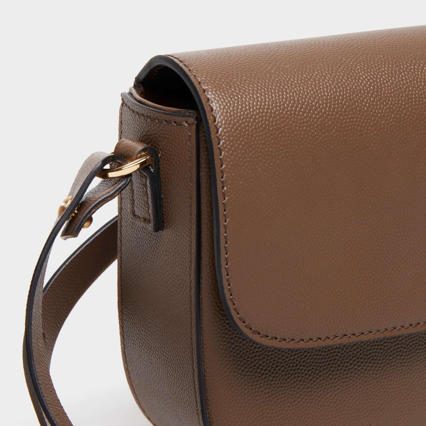 Close-up of curved stitching on taupe calfskin crossbody bag