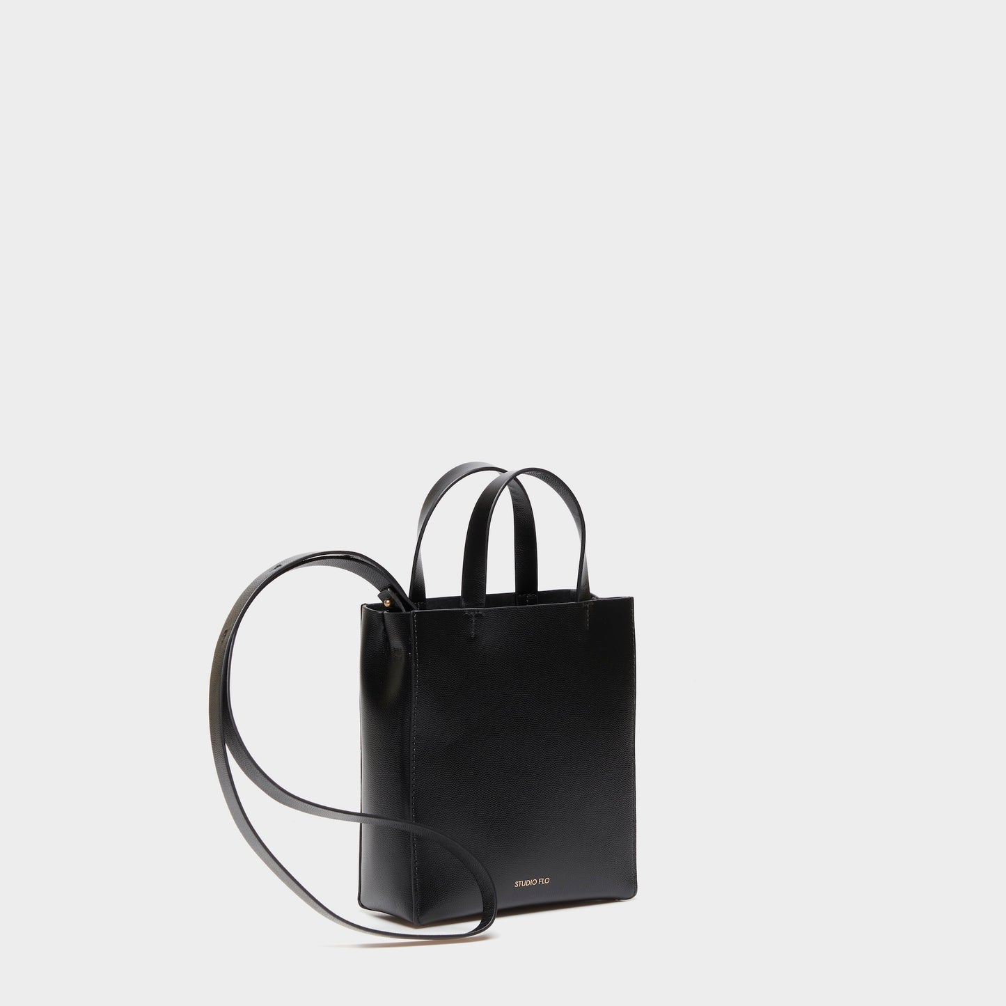 Mini handbag with adjustable strap in black calf leather