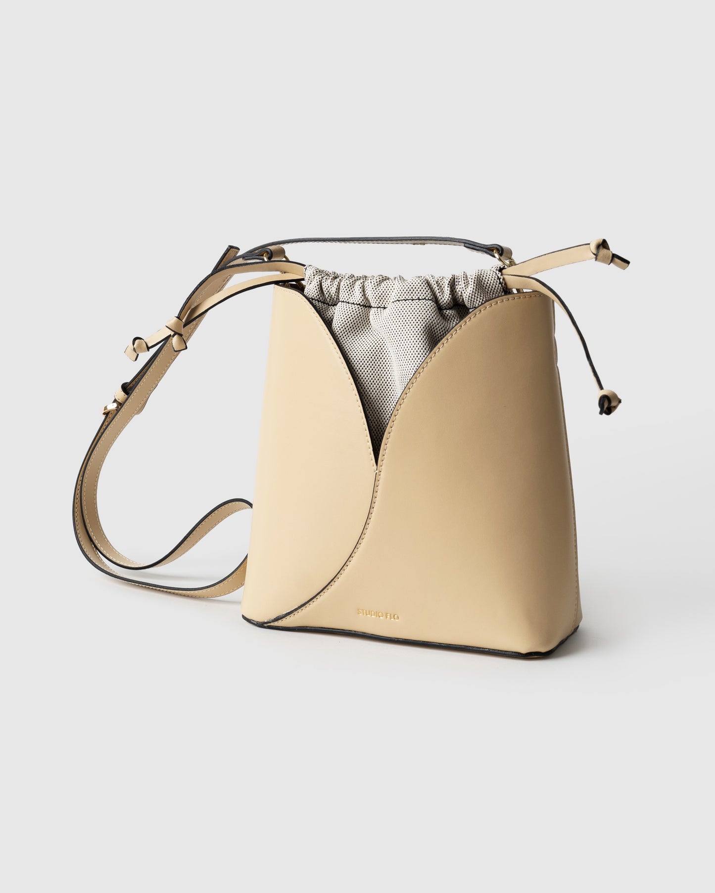 Italian calf leather bucket bag in cream with adjustable strap and top handle