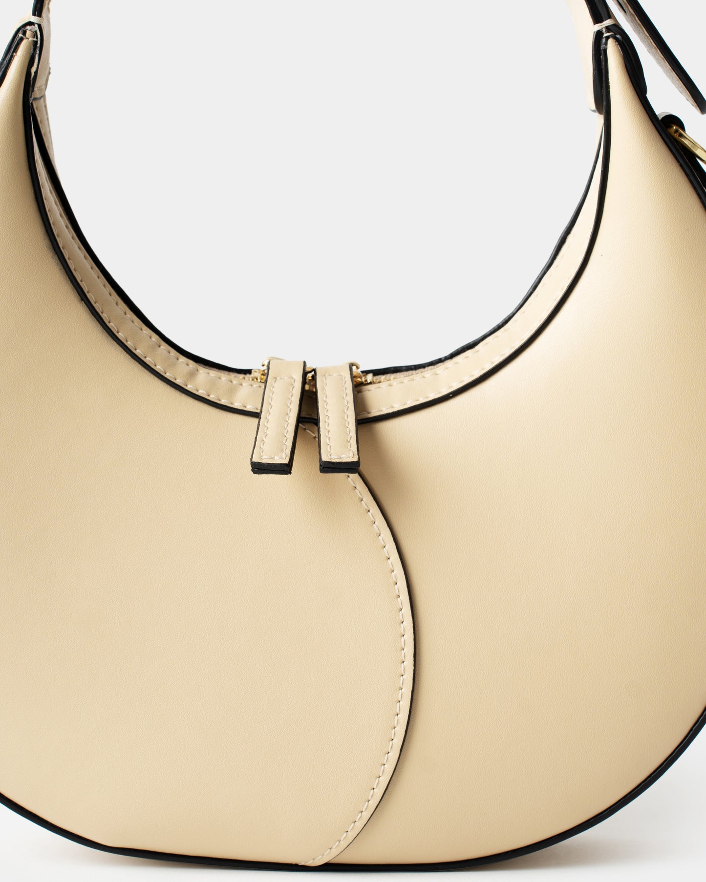 Cream leather moon bag with contrast curved stitching and zip closure