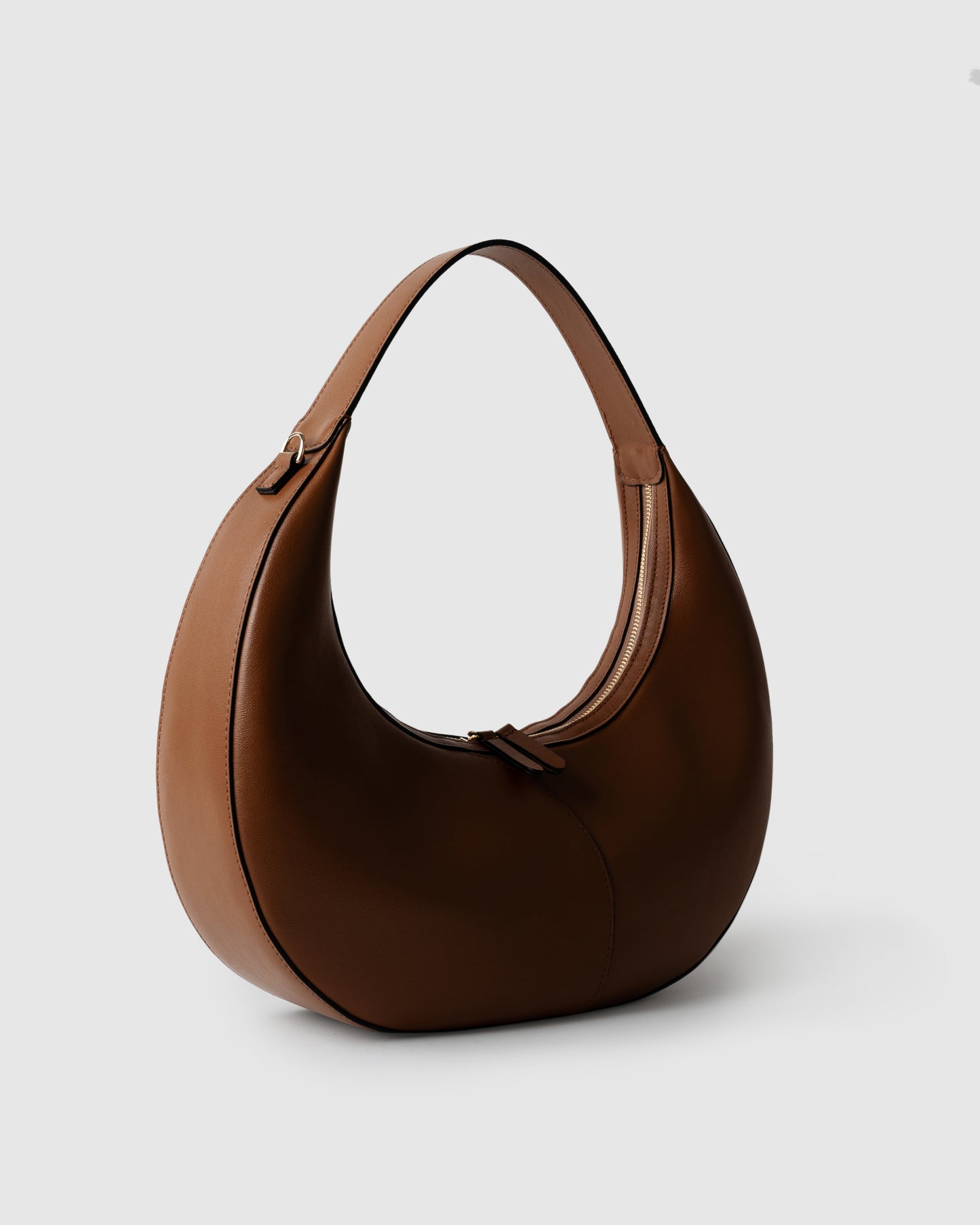 Side view of structured shoulder bag in cognac leather