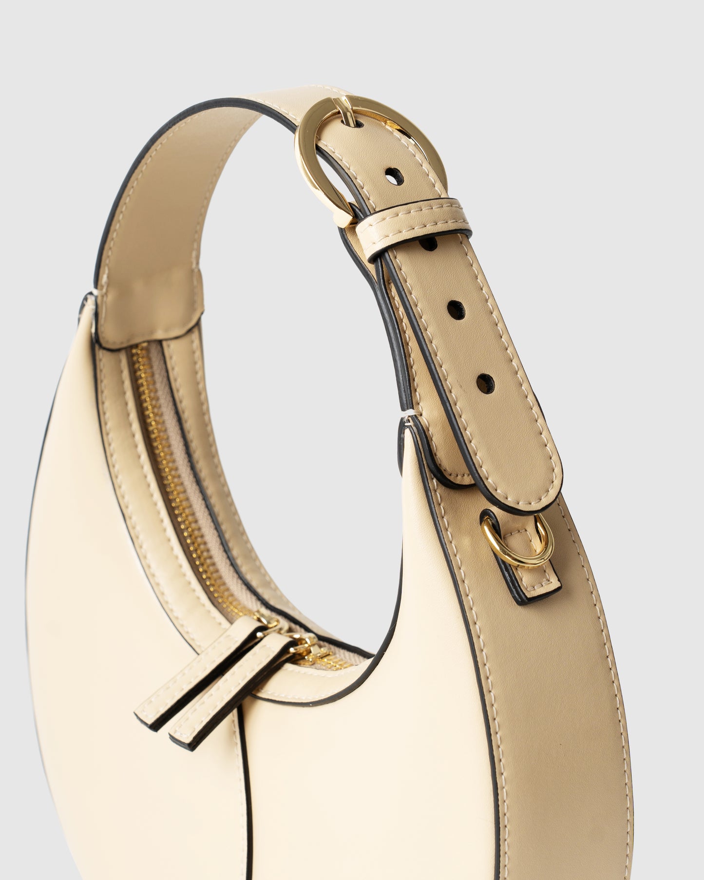 Side view of structured mini shoulder bag in cream leather