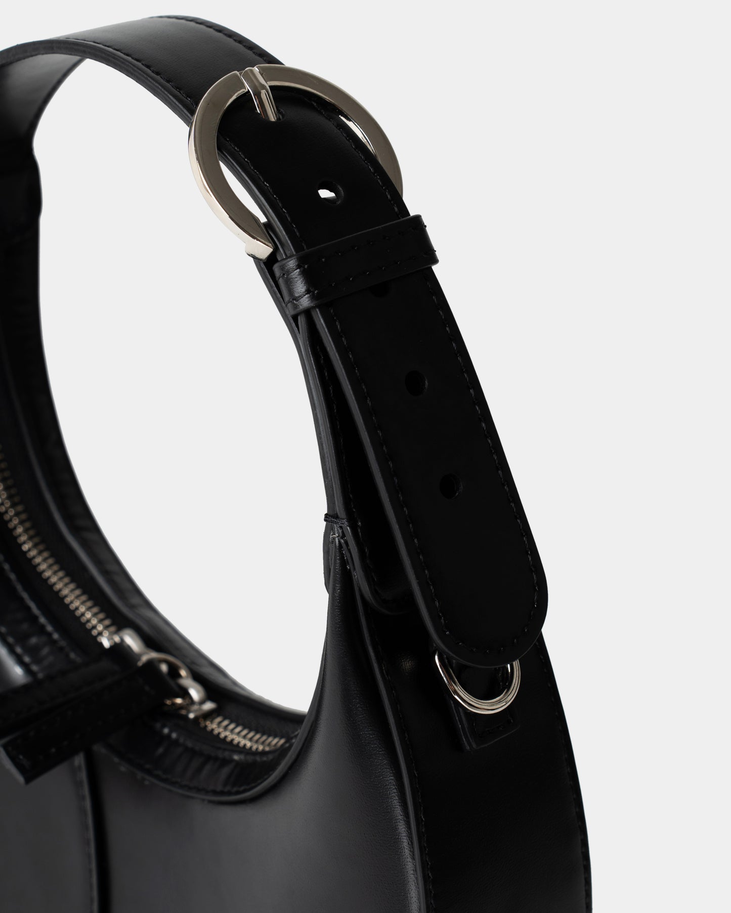 Side view of structured mini shoulder bag in black leather