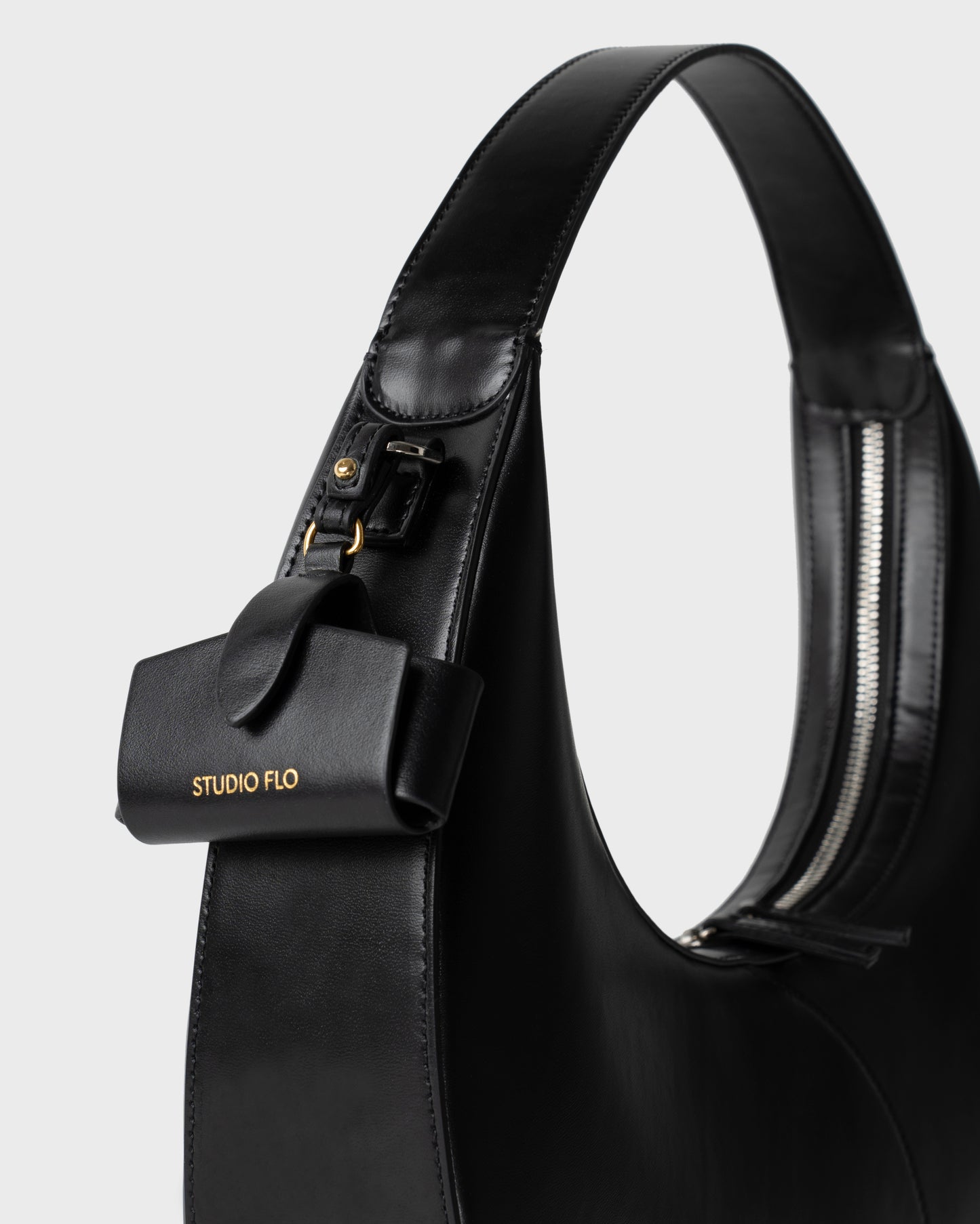 Moon Loop in black with adjustable strap and refined silhouette with Airpods Case Charm