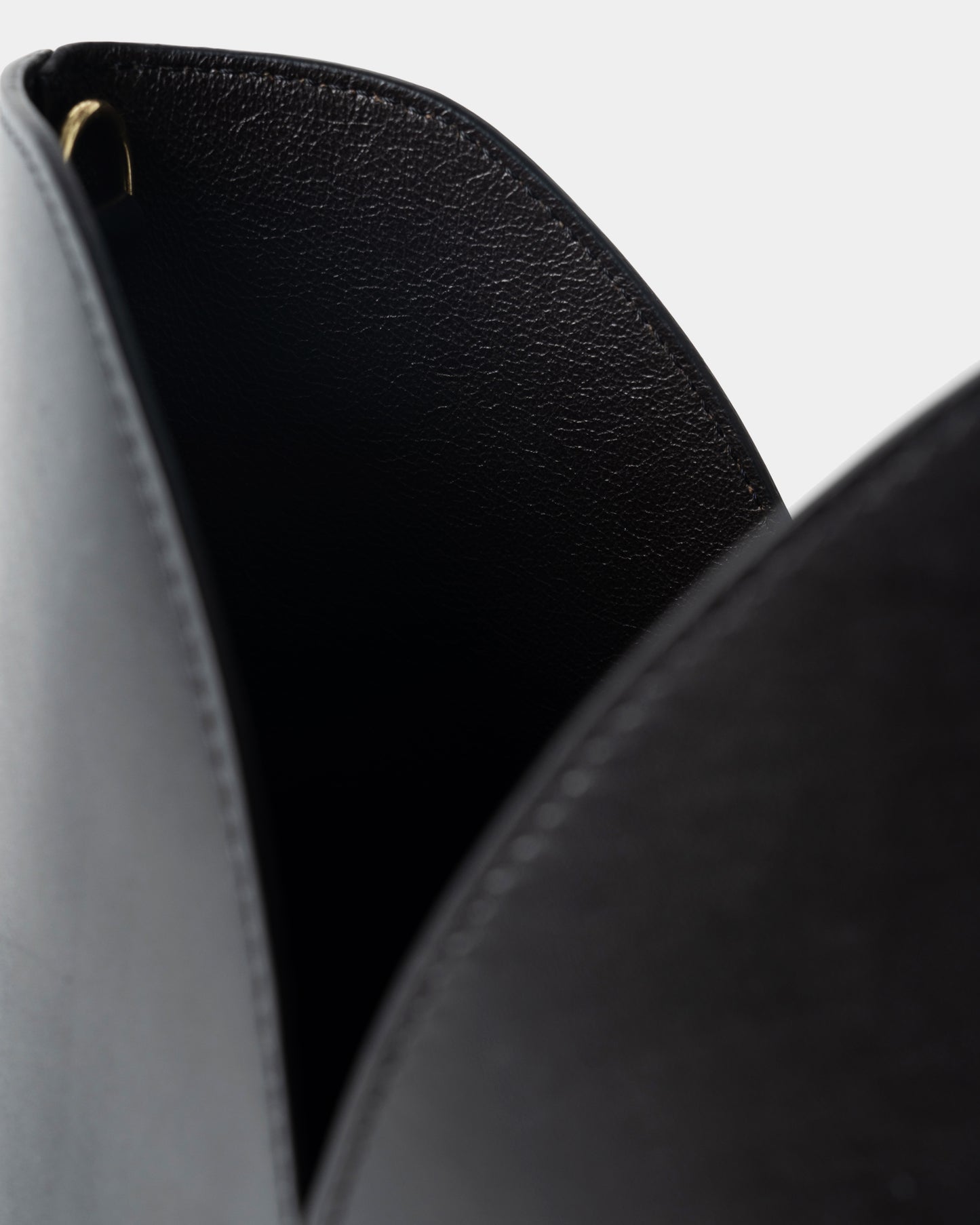 Interior detail of black leather bucket bag with removable pouch