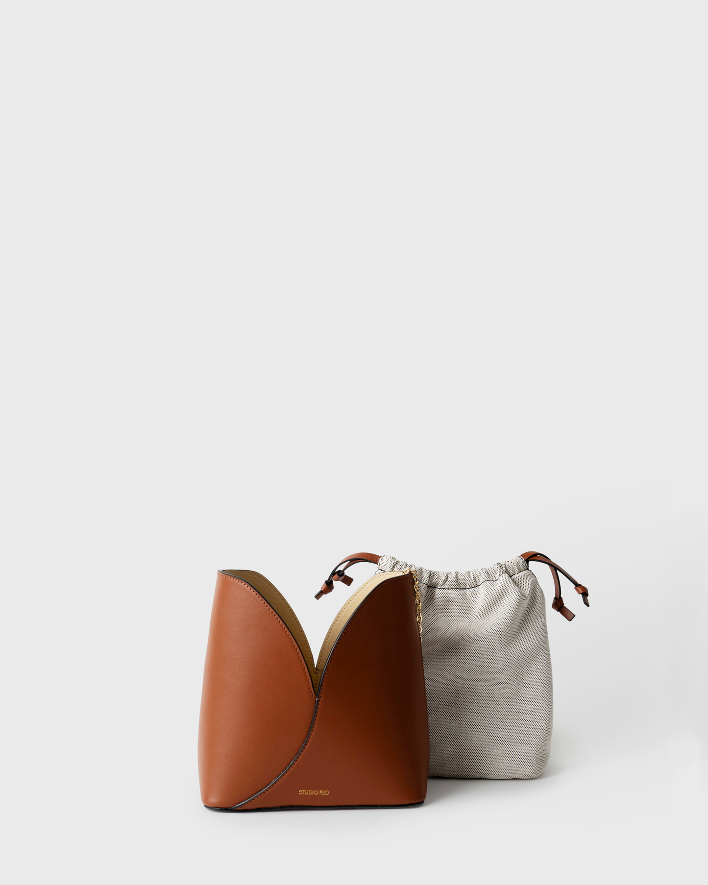 Structured leather bucket bag with two-tone design and silver hardware