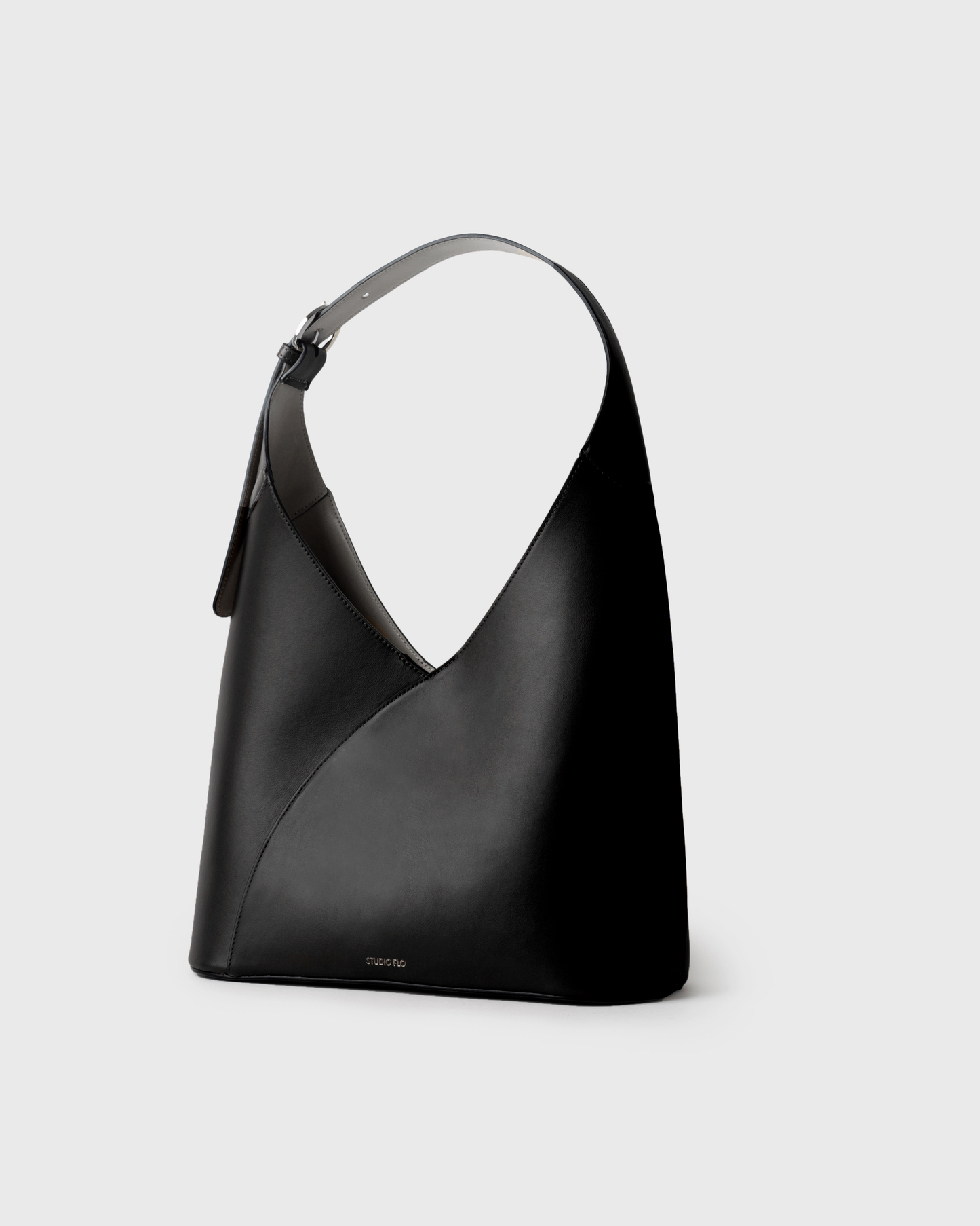Minimalist black hobo bag in calfskin with crescent silhouette