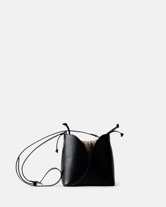 Compact black calf leather bucket bag with curved top and structured shape