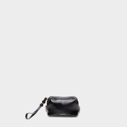 Black calfskin leather mini beauty case with curved silhouette