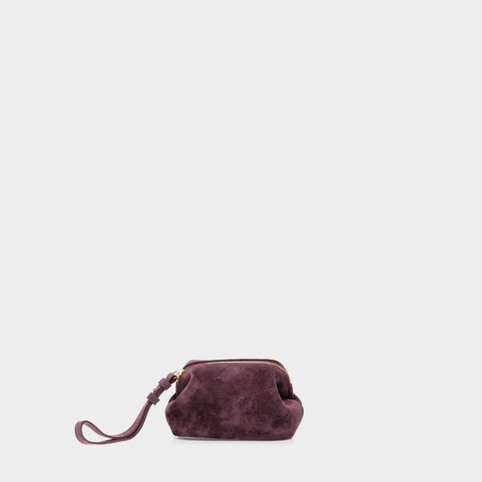 Purple suede mini beauty case with rounded silhouette and zip closure