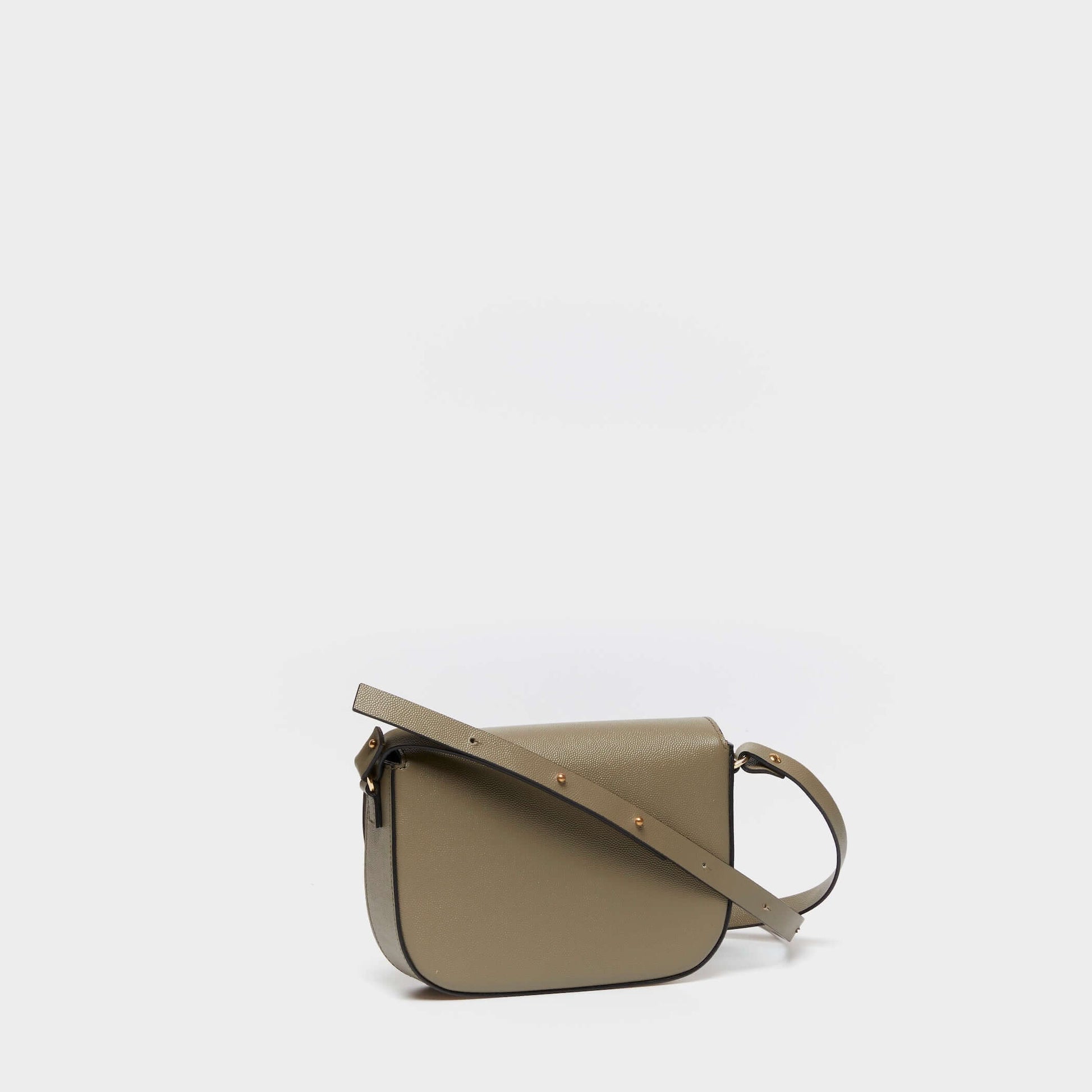 Side view of structured beige leather crossbody bag with adjustable strap