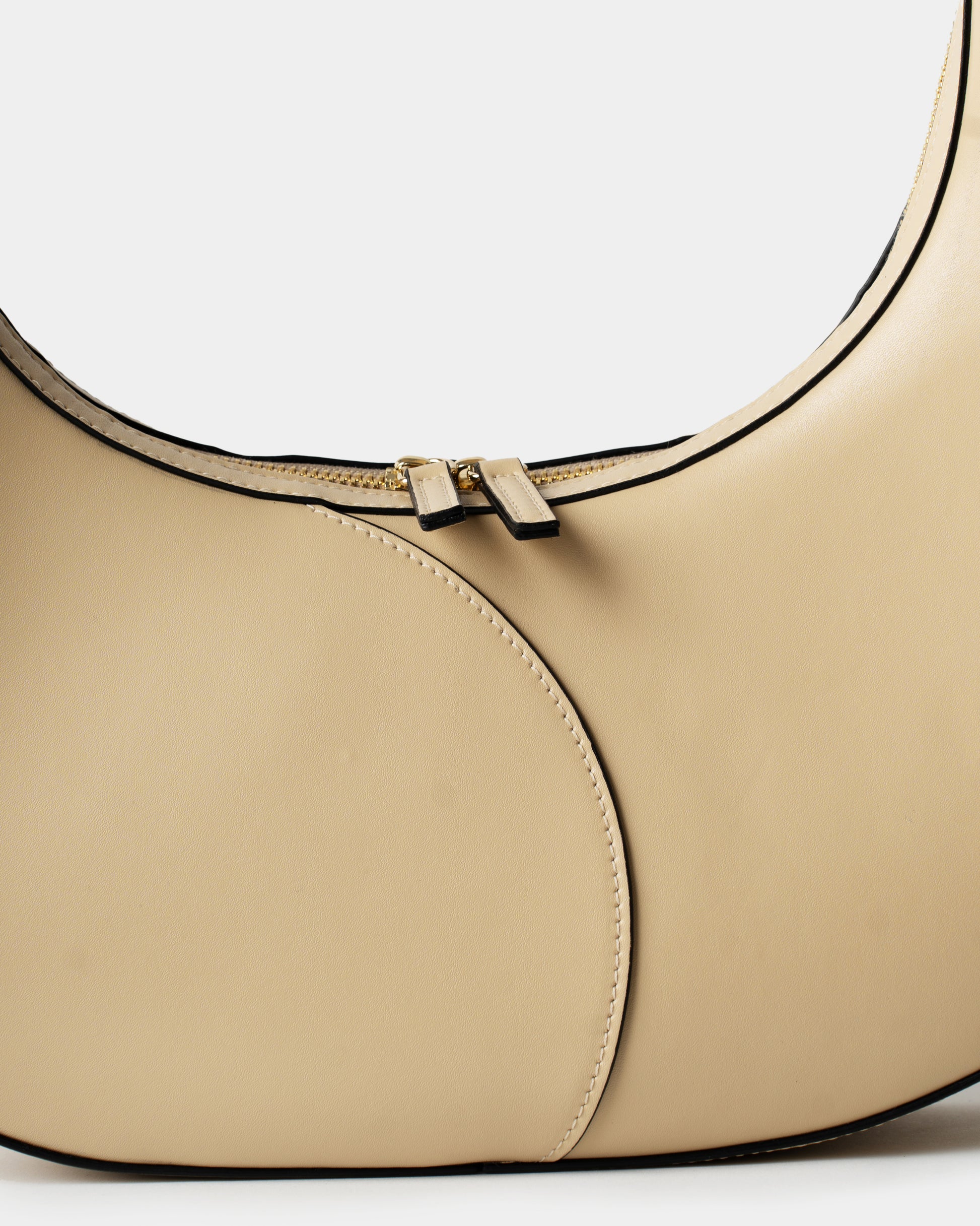 Detail of smooth cream leather and stitching on big crescent bag