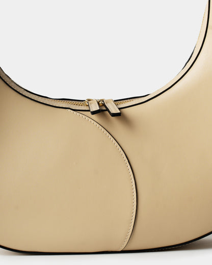 Detail of smooth cream leather and stitching on big crescent bag