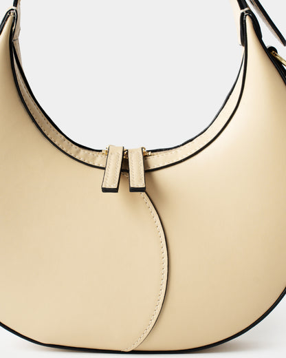Cream leather moon bag with contrast curved stitching and zip closure