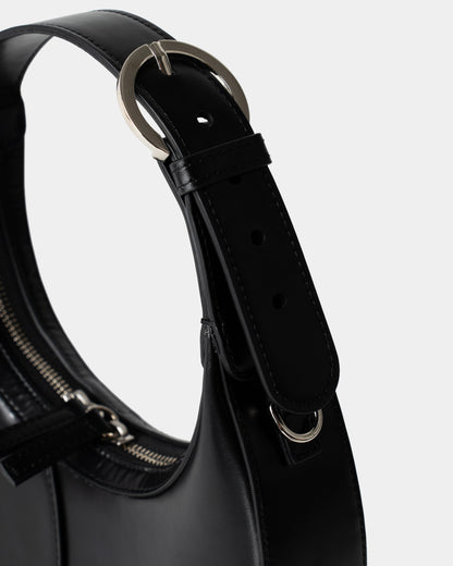 Side view of structured mini shoulder bag in black leather