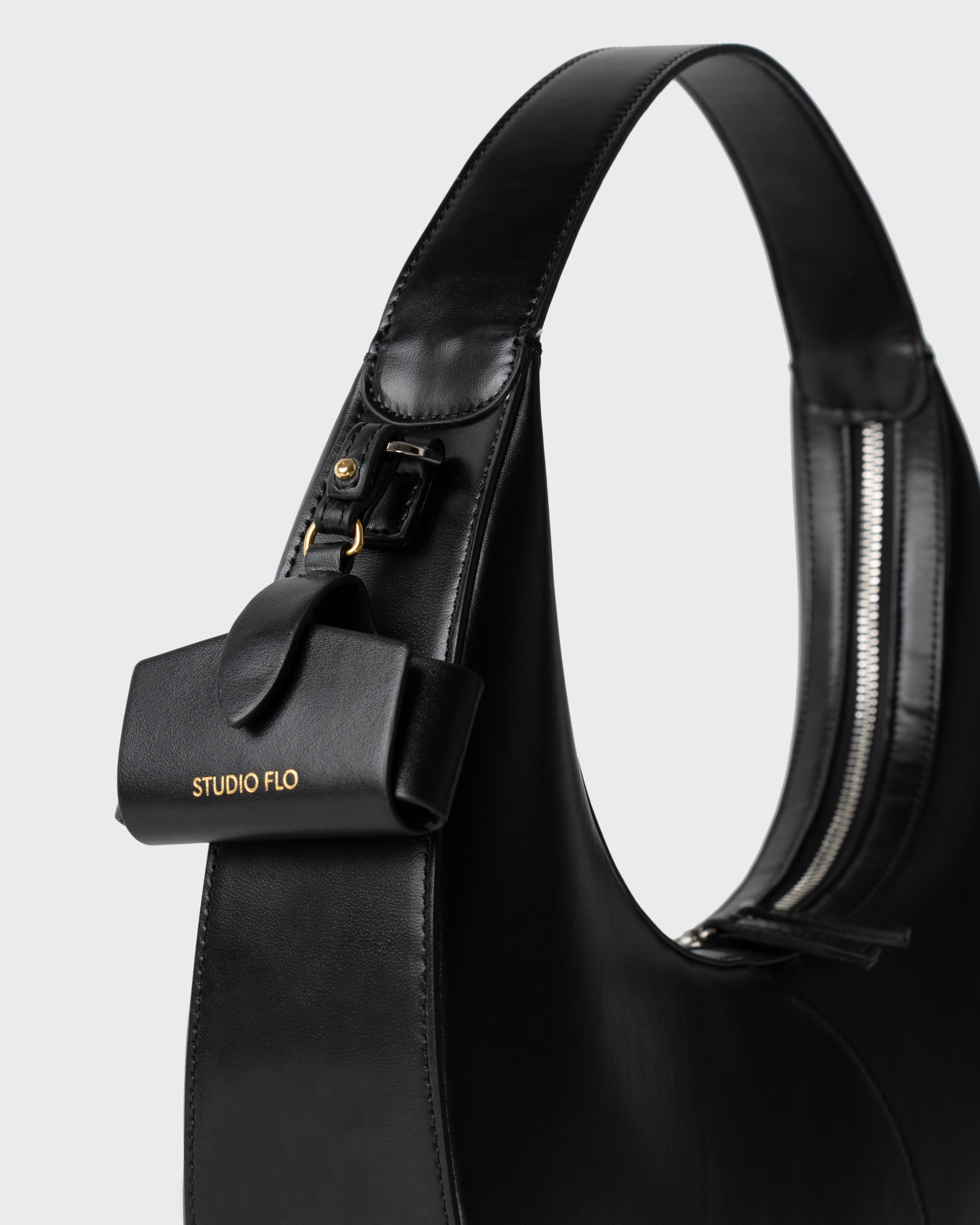Moon Loop in black with adjustable strap and refined silhouette with Airpods Case Charm
