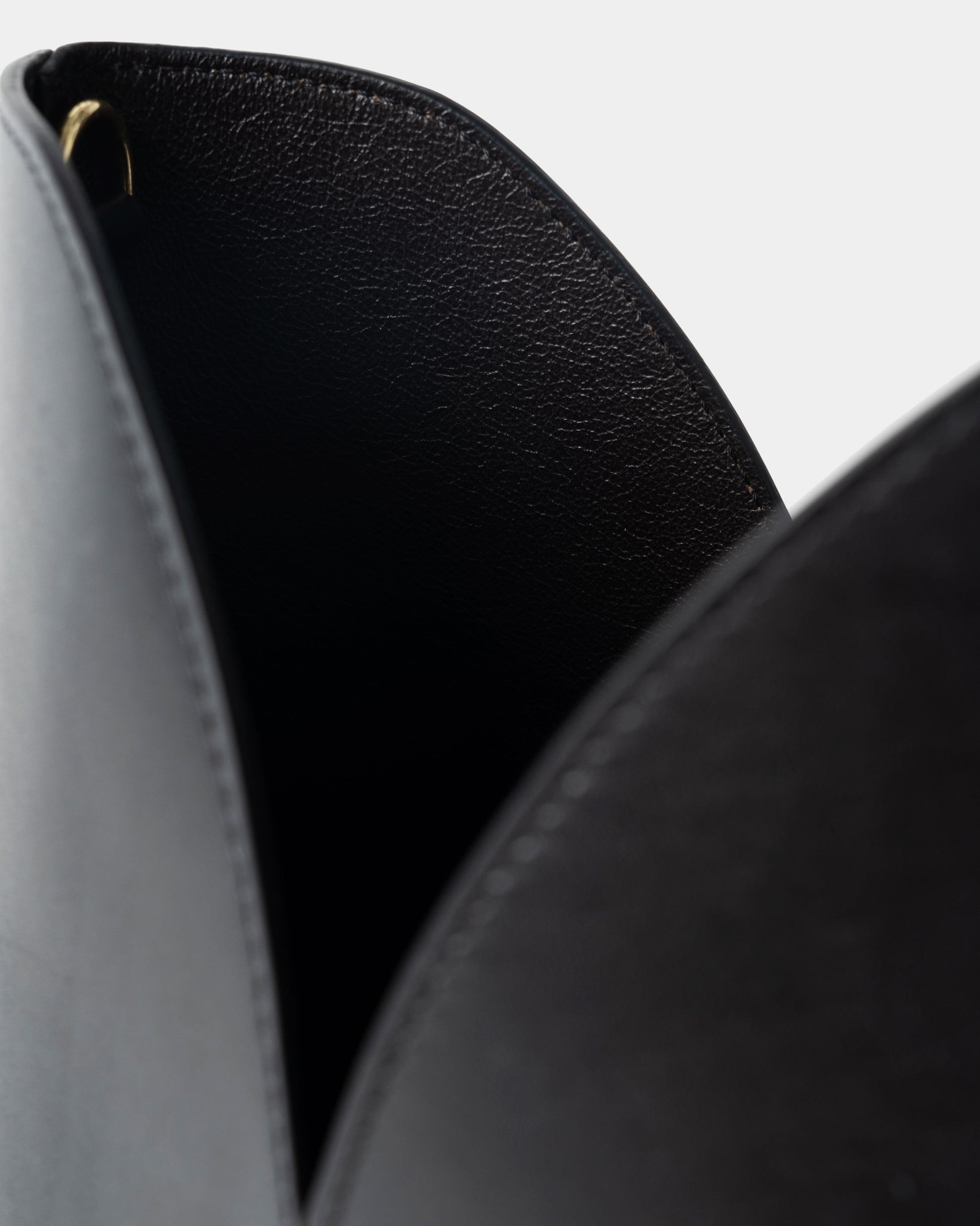Interior detail of black leather bucket bag with removable pouch