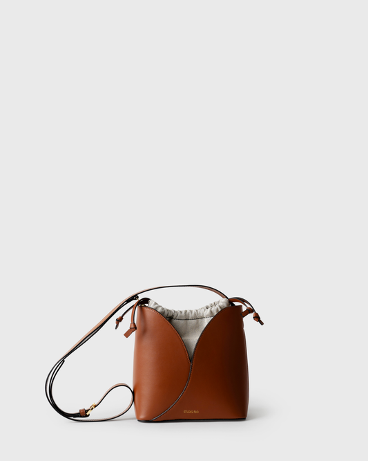 Compact bucket bag in cognac calf leather with curved top and handle