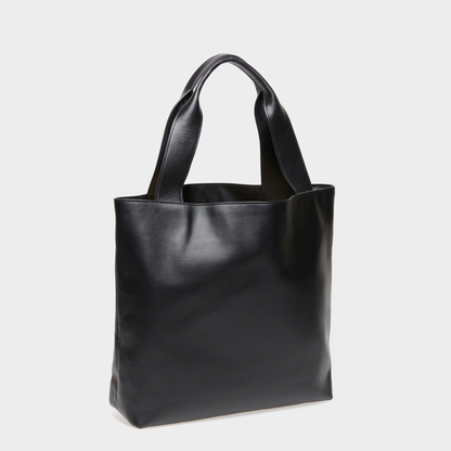 Angled view of the spacious Urban Tote black leather bag